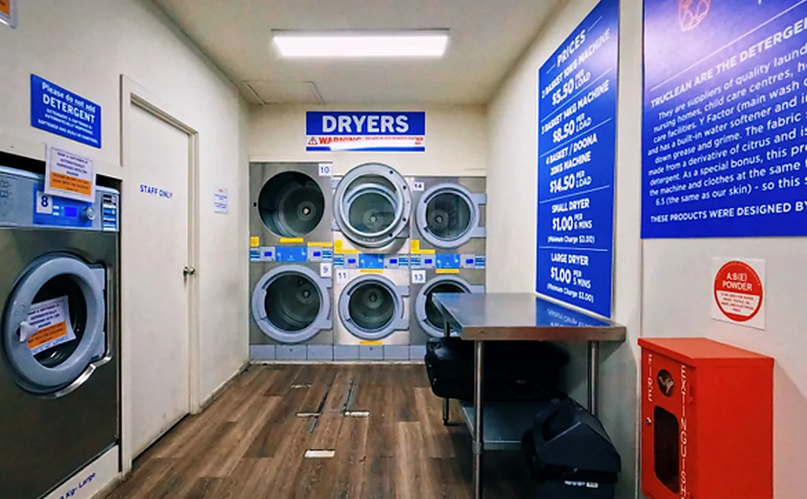 Dryers and folding area at Laundrette @ Beenleigh