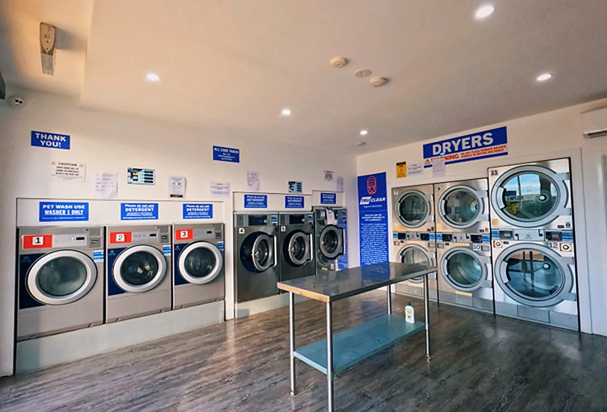 Washers, dryers and folding table at Laundrette @ Redbank
