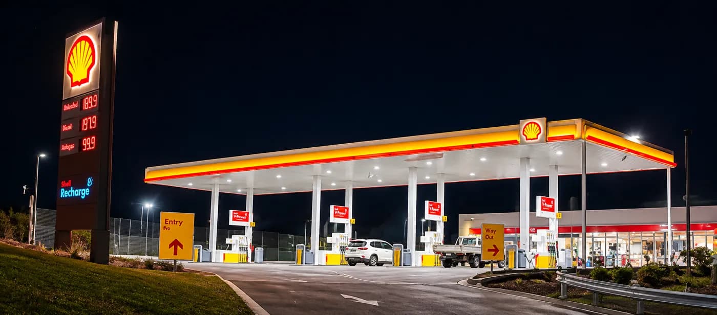 A Shell forecourt lit up at night